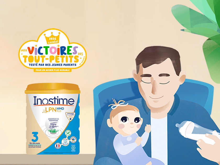 Illustration d’un père tenant un bébé dans ses bras. À côté, un pot de lait infantile Inostime LPNHMO est posé sur une table avec un badge « Victoires des tout-petits 2023 ».